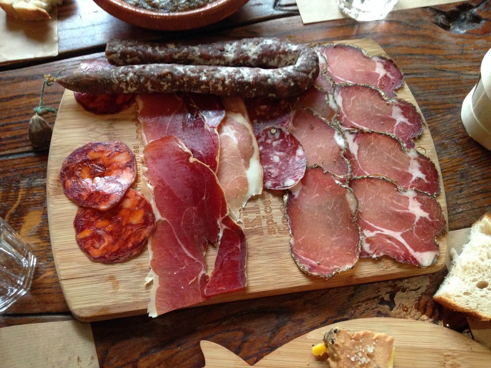 Planche de charcuterie dressée sur une table en bois